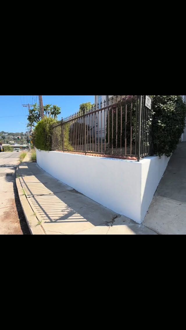 Stucco wall & iron fence restoration